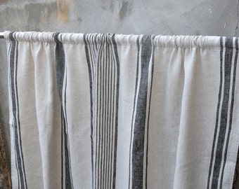 May include: A pair of white linen curtains with black stripes. The curtains are gathered at the top and have a simple, casual style.