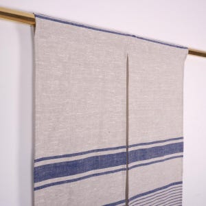 May include: A pair of linen curtains with blue and white stripes. The curtains are hanging from a gold rod.