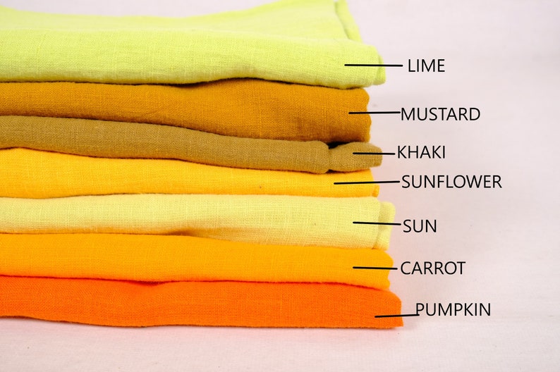 May include: A stack of eight fabric swatches in shades of yellow and orange. The swatches are labelled from top to bottom: Lime, Mustard, Khaki, Sunflower, Sun, Carrot, Pumpkin.
