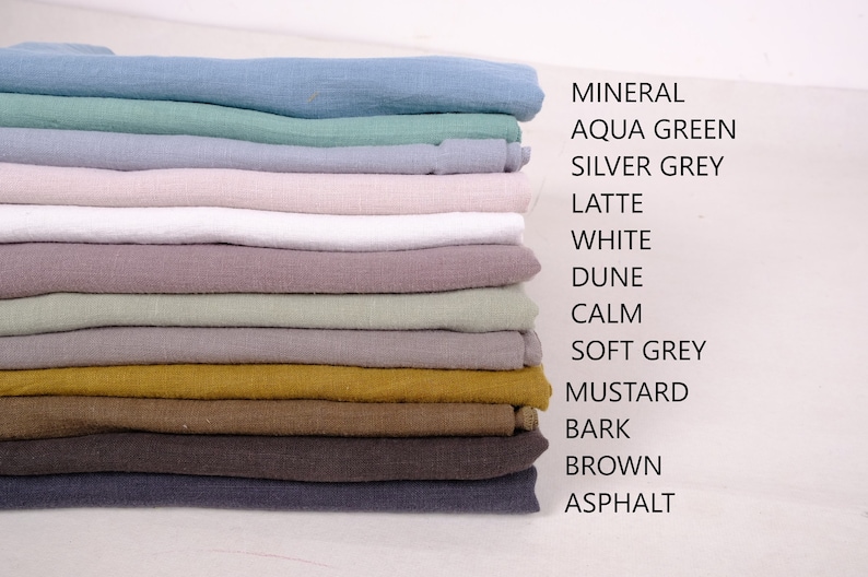 May include: A stack of 12 fabric swatches in various colours, including mineral, aqua green, silver grey, latte, white, dune, calm, soft grey, mustard, bark, brown, and asphalt.