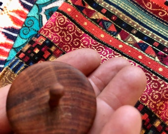 Handcrafted plum wood spinning top: Unique piece with a secure hold