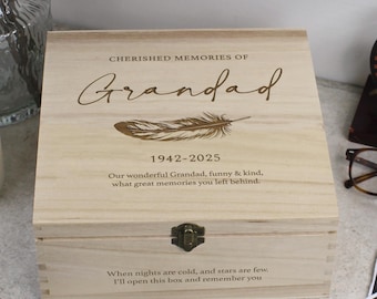 May include: A wooden box with a hinged lid and a brass latch. The box is engraved with the words "Cherished Memories of Grandad 1942-2025" and a feather design. The text below reads "Our wonderful Grandad, funny & kind, what great memories you left behind. When nights are cold, and stars are few, I'll open this box and remember you."