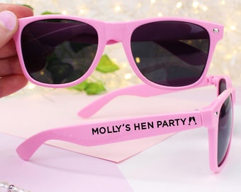 May include: Pink plastic sunglasses with black lenses and the text "MOLLY'S HEN PARTY" printed on the side.
