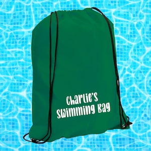 May include: A green drawstring bag with the text "Charlie's Swimming Bag" in white lettering.
