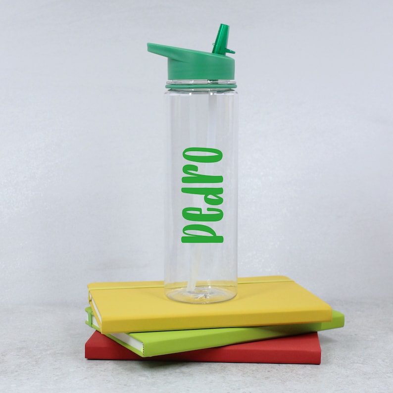 May include: A clear plastic water bottle with a green lid and a green straw. The bottle has the name "Pedro" written on it in green letters.