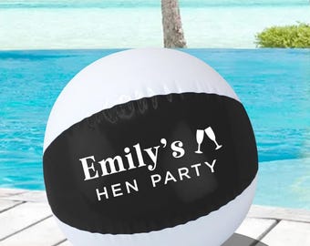 May include: White and black inflatable beach ball with the text "Emily's Hen Party" and two champagne glasses.