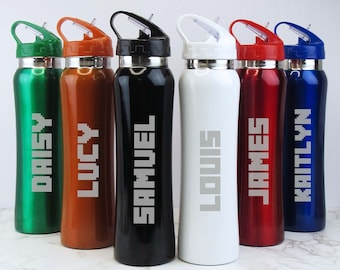 May include: Six personalized stainless steel water bottles with different names, including Daisy, Lucy, Samuel, Louis, James, and Kaitlyn, in a pixelated font. The bottles are green, orange, black, white, red, and blue.