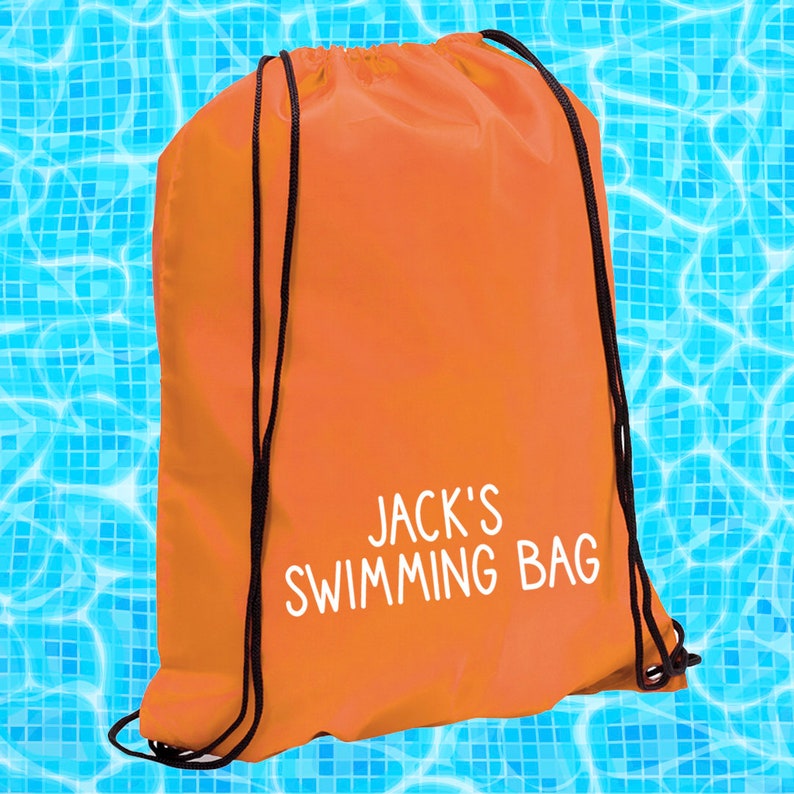 May include: Orange drawstring bag with black drawstrings and the text "JACK'S SWIMMING BAG" in white.