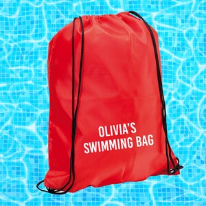 May include: Red drawstring bag with black drawstrings and the text "Olivia's Swimming Bag" in white.