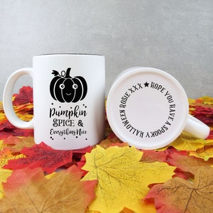 May include: White ceramic mug with a black rim and handle, featuring a black pumpkin graphic and the text "Pumpkin Spice & Everything Nice." The bottom of the mug has the text "Halloween Rosie XXX Hope You Have A Spooky".