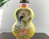 The glazed snuff bottle is hand-painted by birds and flowers