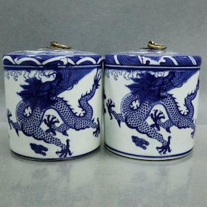 A pair of exquisite blue-and-white porcelain covered jars with dragon designs, hand-painted purely by hand, from China.