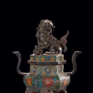May include: An antique bronze incense burner with a detailed lion figure on top. The burner features a turquoise base with floral patterns in red, yellow, and blue. It has curved handles and ornate legs, showcasing a classic Asian design.