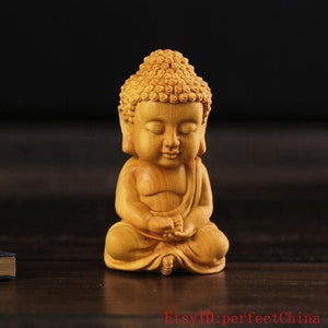 Natural boxwood carved like a Buddha statue