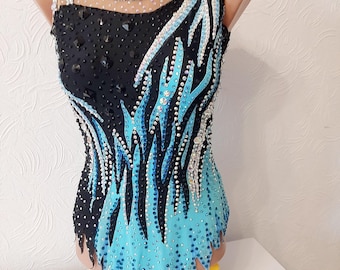 May include: A black and blue leotard with a flame design and rhinestones. The leotard has a mesh neckline and a scalloped hem.
