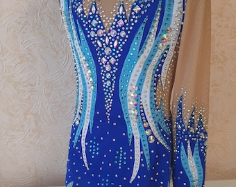 May include: A blue, white and teal leotard with a crystal design. The leotard has long sleeves and a scoop neck.