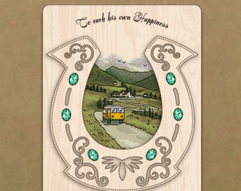 May include: A wooden horseshoe-shaped embroidery frame featuring a cross-stitch landscape with a yellow camper van, green mountains, and the text "To each his own Happiness". The frame is decorated with five green gems and scrollwork.