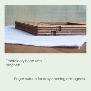May include: A wooden embroidery hoop with magnets. The hoop has finger cutouts for easy opening.