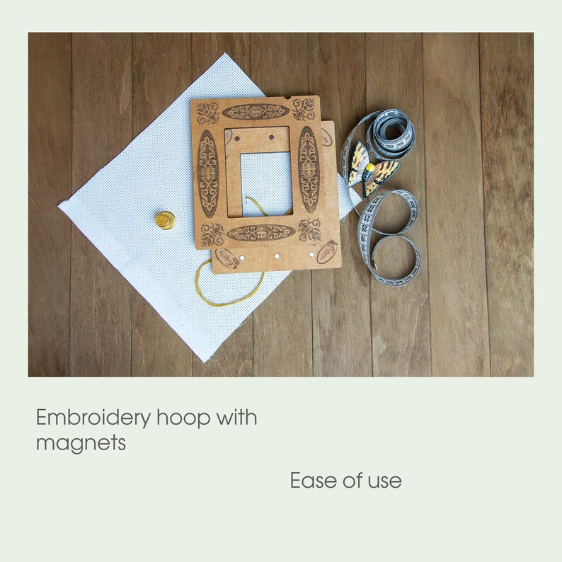 May include: A wooden embroidery hoop with magnets, a white fabric, a gold thimble, and a measuring tape with a butterfly design.