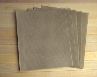 May include: A stack of five rectangular brown mesh baking sheets with a fine grid pattern. Each sheet features a uniform perforated texture designed for heat circulation, arranged in a slightly fanned-out overlapping formation.