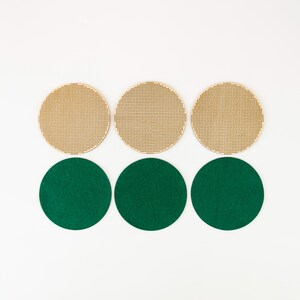 May include: Six circular craft supplies. Three are light brown with a perforated grid pattern. The other three are solid green circles. All are arranged on a white background.