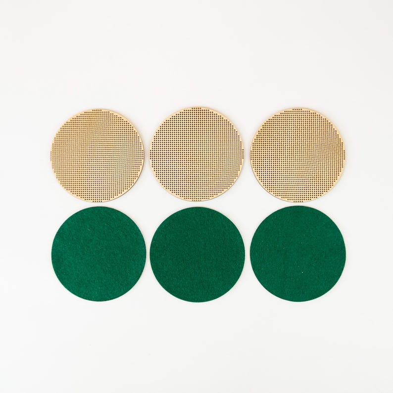 May include: Six circular craft supplies. Three are light brown with a perforated grid pattern. The other three are solid green circles. All are arranged on a white background.