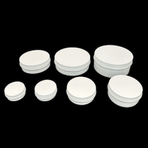 May include: Set of seven white metal tins in various sizes. The tins have a smooth, white finish and a slightly raised rim around the top.