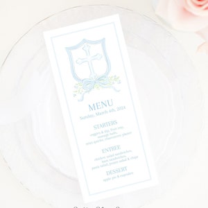 Könnte beinhalten: Eine hellblaue Speisekarte mit einem weißen Kreuz und einer blauen Schleife auf einem Schild. Der Text auf der Karte lautet "MENU", "Sonntag, 4. März 2024", "STARTERS", "veggies & dip fruit tray", "sausage balls", "mint quare, chenmurzie platter", "ENTREE", "chicken salad sandwiches", "ham sandwiches", "pasta salad, potato salad & chips", "DESSERT", "apple pie & cupcakes".