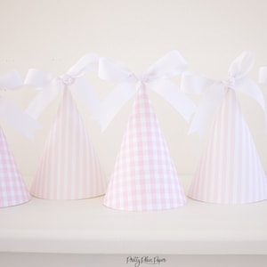 May include: Pink and white gingham and striped party hats with white satin bows. The hats are arranged in a row on a white surface. "Pretty Plain Paper" is written on the surface.