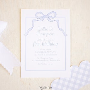 May include: A blue and white invitation with a blue bow and the text "Lottie To Thompson will be celebrating her first birthday. Please join us SATURDAY, MAY 5TH at 2 o'clock in the afternoon the Thompson Home 242 Henderson Road Thomas, VA RSVP to (1) 240-3971 Pretty Plain Paper"