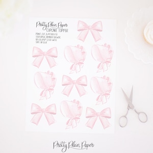 May include: Printable cupcake toppers featuring pink watercolor bows and bonnets. The sheet includes instructions to print, cut, and attach to toothpicks, bamboo skewers, or lollipop sticks with tape or glue.
