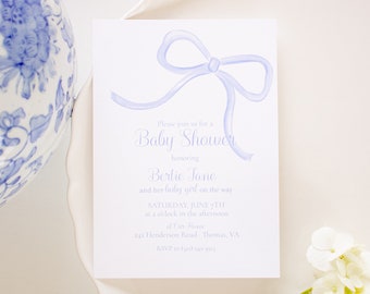May include: A light blue baby shower invitation with a watercolor illustration of a bow. The invitation reads "Please join us for a Baby Shower honoring Bertie Jane and her baby girl on the way Saturday, June 7th at 2 o'clock in the afternoon at Our Place 242 Henderson Road, Thomas, VA RSVP to [email protected]"