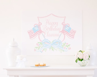 May include: A watercolor illustration of a pink and blue shield with the text "Happy Birthday Elanna" and two American flags. The shield is surrounded by a floral design with blue and white ribbons.
