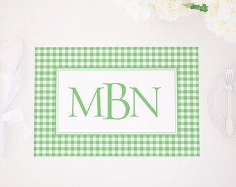 May include: Green and white gingham placemat with a white border and the monogram "MBN" in green.