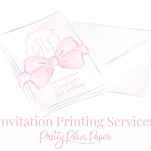 May include: A stack of white invitation cards with a pink bow and monogram. The text on the card reads "Please join us to celebrate Caroline's first birthday". The image also includes a white envelope. The text at the bottom of the image reads "Invitation Printing Services Pretty Plain Paper".