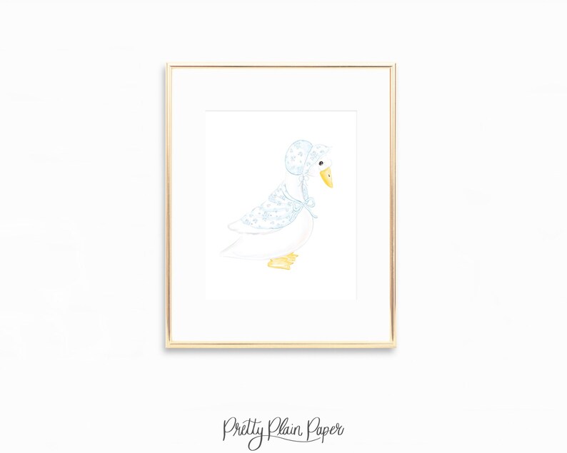 May include: A framed watercolor print of a white goose wearing a blue bonnet and shawl with a floral pattern. The goose has a yellow beak and feet. The print is in a gold frame, and the words "Pretty Plain Paper" are at the bottom.