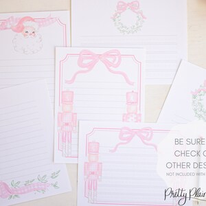 May include: Set of pink and green Christmas stationery featuring a nutcracker, a wreath, and a bow. The stationery has lined paper for writing letters.