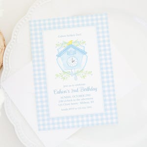 May include: A light blue gingham-patterned invitation for Cohen's 2nd birthday. The invitation features a watercolor illustration of a blue cuckoo clock with a yellow bird and the text "Cohen Strikes Two!" and event details.