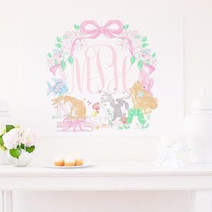 May include: A whimsical, framed artwork featuring a pink bow and floral wreath surrounding a monogram. The illustration includes a fish, rabbit, hen, bunnies, a bear, and a caterpillar. The color palette is soft pink, green, and pastel hues.
