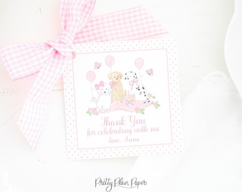 Op de afbeelding: Roze en witte bedankkaart met een stippenrand. De kaart heeft een cartoonillustratie van drie honden met roze ballonnen en een verjaardagstaart. De tekst op de kaart luidt "Bedankt voor het vieren met me, met liefde, Anna".