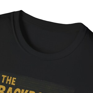 Viral Backrooms horror image on black T-shirt, with yellow fluorescent maze and shadowy entity, popularized by TikTok, YouTube horror ARGs, and Reddit lore fans.