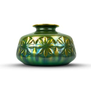 May include: A green ceramic vase with a floral pattern. The vase has a rounded body and a narrow neck with a gold rim. The floral design is embossed around the body of the vase. The vase is approximately 6 inches tall.
