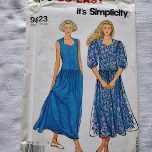 May include: Vintage Simplicity sewing pattern envelope. The envelope features illustrations of two dresses. The text on the envelope reads "It's SO EASY" and "it's Simplicity". The pattern size is 10-20.