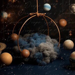 May include: A gold metal hoop with a blue and gray cloud inside. The hoop is suspended from the ceiling with rope. There are several planets hanging from the hoop, including a blue and white planet, a brown planet, and a brown and white planet.