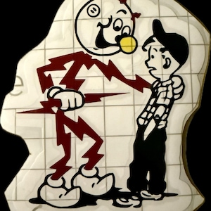 May include: A cartoon-style sticker featuring a white character with a round head, holding a lightning bolt, confronting a boy in a plaid shirt and cap. The design uses black, white, and maroon colors. The sticker is on a grid background.