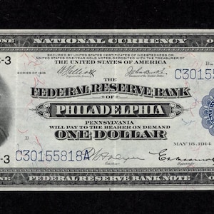 Peut inclure: Un billet d'un dollar ancien de la Federal Reserve Bank de Philadelphie, avec un portrait de George Washington. Le billet est daté du 18 mai 1914 et porte la mention "National Currency".