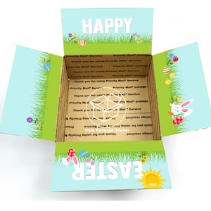 May include: A brown cardboard box with a blue and green Easter-themed sticker. The sticker features the words "Happy Easter" and a sun, bunny rabbit, and Easter eggs. The sticker is designed to be used as a care package sticker.