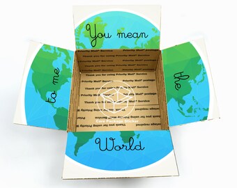 May include: An open cardboard box with a world map design. The inside of the box has the words "You mean the world to me" written on it. The box is a care package sticker.