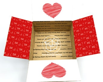 May include: A brown cardboard box with a red heart design on the front and back. The box is open and the inside is lined with white paper. The box has a sticker that says "Care Package Sticker" and "Thank you for using Priority Mail Service".