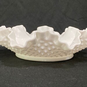 May include: White milk glass bowl with a ruffled edge and a textured, dotted surface.